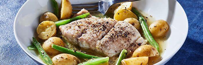 Oven-baked bacala fish with roasted potatoesimage