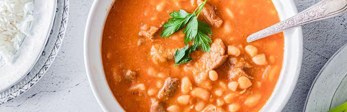White beans with meat and a spicy red sauceimage